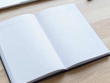 An open notebook with clean, structured bullet points on a wooden table, bright neutral daylight, soft blue tones, sharp focus, 35mm