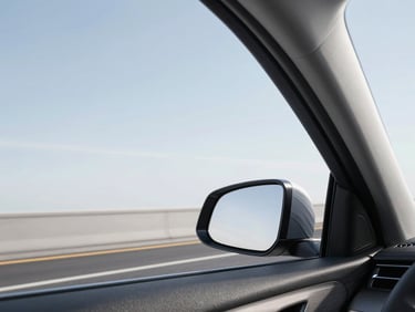 Clean vehicle interior looking out of the passenger window onto a clear highway, bright neutral daylight