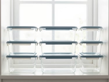 Perfectly organized pantry shelves with clear stackable containers, straight-on eye-level shot, bright natural window light, 50mm lens