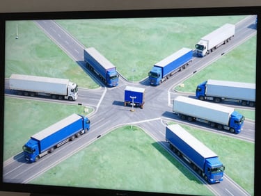 Overhead view of a complex logistics network map on a screen, with trucks moving, professional blue and green tones, 35mm