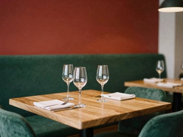 Cozy Scandinavian-style restaurant dining room, warm ambient light, wooden tables, empty wine glasses, inviting atmosphere