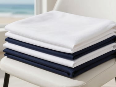 Macro detail shot of clean, neatly folded fine upholstery linens on a modern designer chair, soft daylight, sharp focus