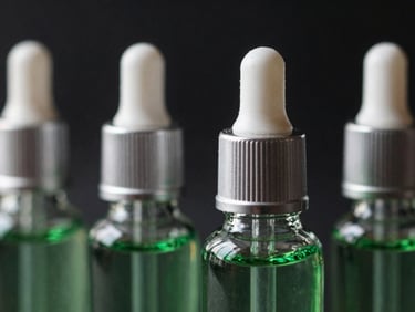 Close-up of premium glass e-liquid bottles with elegant droppers, emerald green liquid accents, moody dark background, 35mm