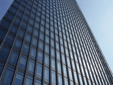 Wide-angle architectural photograph of a modern skyscraper facade design, featuring intricate structural details and sleek glass panels, high-contrast daylight, sharp shadows.