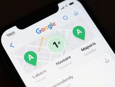 Tight overhead crop of a mobile phone screen displaying a Google Maps local pack result, three business pins visible, rank position #1 highlighted with a subtle green annotation, screenshot-native even lighting, no physical props