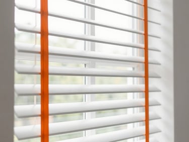 Stylish window blinds partially open, showing natural light filtering through, clean and functional design, 35mm