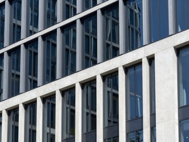 Abstract architectural perspective of a modern concrete and glass building, clean lines, bright daylight, 35mm
