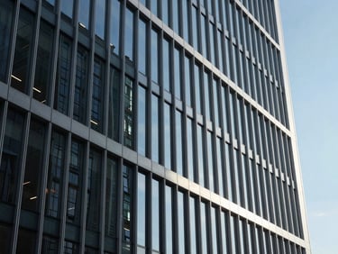 Wide architectural perspective of a modern high-end corporate glass facade, sharp focus, cool office daylight, deep navy shadows, 35mm