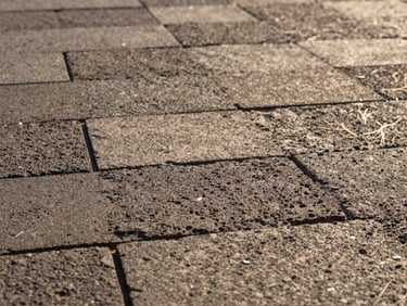 Intimate close-up of volcanic stone tiles being inspected, soft natural lighting, focus on texture and craftsmanship