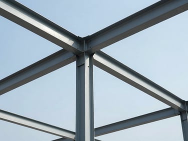 Close-up of a structural steel frame under bright daylight, sharp architectural lines