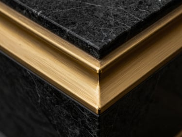 Extreme macro close-up of a brushed brass architectural detail intersecting with a sharp marble edge, high-contrast lighting, matte black and gold tones.