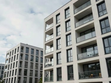 Wide environmental shot of a modern apartment block in Berlin, clean architectural lines, overcast sky, soft natural daylight.