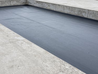 Architectural photography of industrial waterproofing membrane application on a concrete structure, cool concrete tones, sharp focus.