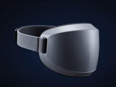 Industrial product photography of the Silent Mask wearable device, showcasing the ergonomic design and secure strap mechanism, dramatic side-lighting, cool steel-grey tones