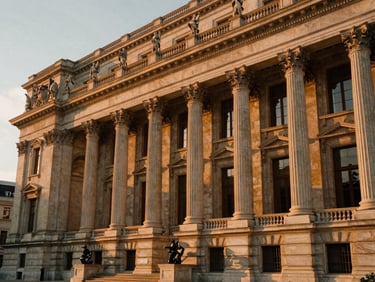A majestic neoclassical stone facade with tall columns under warm sunset light, elegant and grand architectural details, 35mm film look.
