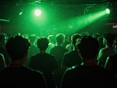Low-angle wide shot of a sweat-drenched crowd in motion under high-contrast acid green strobe lights, deep shadows, heavy film grain, raw underground club energy.