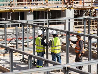 Active commercial construction site, workers in safety-certified gear coordinating on steel framing, bright daylight, sharp focus