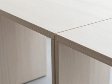 Close-up of minimalist wood furniture craftsmanship, clean lines, precise joinery, bright architectural studio lighting