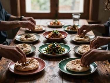 A rustic overhead table spread with various small plates, hands reaching for flatbread, moody shadows, rich culinary journal aesthetic.