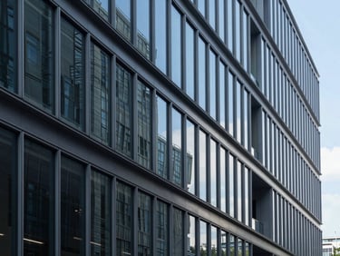 Crisp architectural photography of a modern glass office building corridor, structured lines, deep blue shadows, cool daylight, 35mm