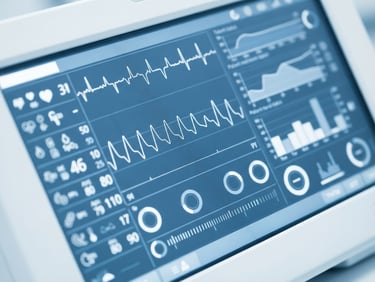 Macro close-up of a high-precision medical device screen showing clinical data, bright sterile white lighting with clean blue undertones, sharp focus, 50mm