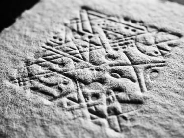 Close-up black and white photograph of heavy paper stock with deep letterpress indentation, stark shadows, high contrast editorial style, 35mm film grain