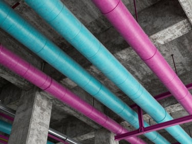 Orthographic top-down view of a complex HVAC ductwork layout color-coded in cyan and magenta, overlapping structural concrete columns, Revit viewport style.