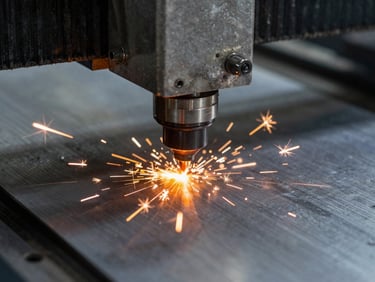 Macro close-up of CNC laser cutter head emitting intense orange sparks on a thick steel plate, high-contrast industrial lighting, cool steel tones, 50mm