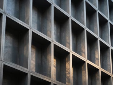 Architectural steel lattice panel installed in a modern building facade, high-contrast geometric shadows