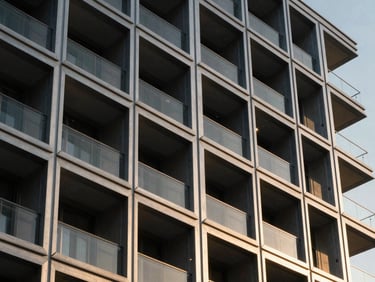 Modern architectural steel lattice celosía on a luxury residential facade, warm sunset light filtering through geometric patterns, clean shadows