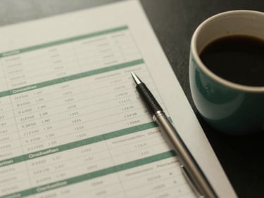 Overhead shot of a financial report with key sections highlighted, next to a pen and a cup of coffee, soft natural window light, muted forest green and cream tones, shallow depth of field, 35mm