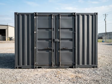 Wide-angle industrial shot of a pristine charcoal-gray storage container positioned on a clean gravel yard, sharp morning sunlight highlighting steel welds and heavy-duty locking bars, 35mm lens.
