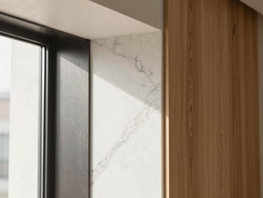 Close-up architectural detail of white marble vein meeting dark brushed steel and natural oak wood grain, soft daylight.