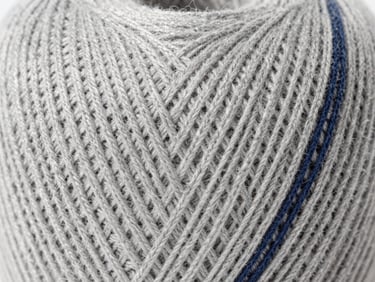 Macro shot of light grey organic cotton yarn weave, bright neutral daylight, high-contrast textile structure
