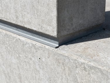Extreme close-up of a finished concrete join, high-contrast daylight, sharp structural detail, 35mm