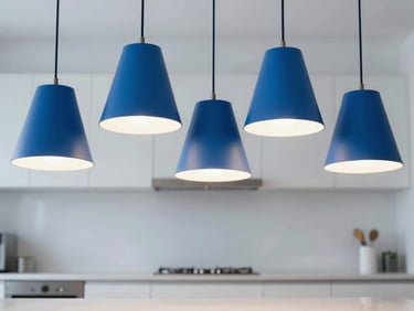 Modern pendant lights with geometric shades hanging over a kitchen island, casting bright, cool light, bold blue and white tones, crisp clean focus, 35mm lens