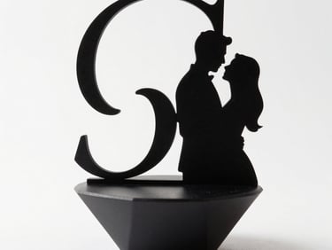 Studio-lit product shot of a set of custom 3D-printed wedding cake toppers and decorative event pieces arranged on a neutral white surface, soft strobe lighting, precise detail on surface finish, clean background, no faces