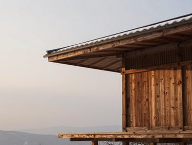 Architectural detail of a minimalist wooden ryokan pavilion surrounded by soft, diffused overcast light and light snow, clean lines.