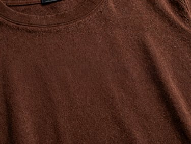 Close-up of a dark brown cotton t-shirt showing clean stitching and premium knit texture