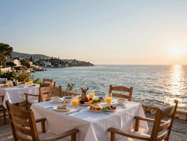 Private terrace with wooden chairs, fresh local breakfast laid out, panoramic view of the Aydıncık bay at sunset