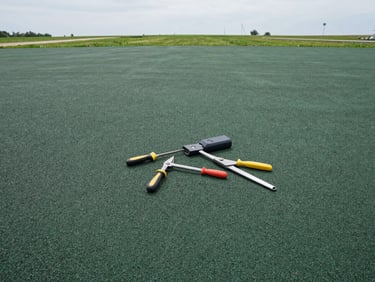 Architectural detail of seamless poured-in-place green rubber flooring installation, professional tools, soft overcast daylight