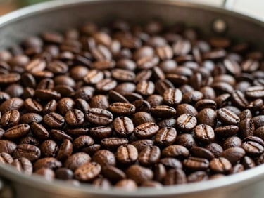 Close-up of roasted coffee beans cooling in a metal roasting tray, rich brown tones, warm natural light, shallow depth of field