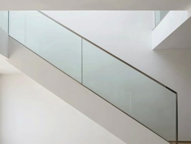 Modern minimalist staircase with a seamless self-supporting glass balustrade, clean architectural lines, natural light, 35mm
