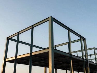 Low angle shot of a modern industrial building steel frame against a clear sky