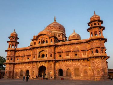 Majestic wide-angle view of Mysore Palace at golden hour, the stone facade glowing warm orange under a clear sky