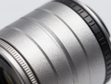 Macro lens shot of a sleek aluminum electronic device enclosure, cool metallic tones, shallow depth of field, sharp studio lighting