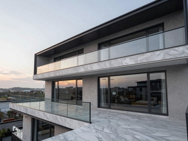 Exterior of a modern linear penthouse balcony, clean glass railings, marble floor, sunset sky reflected