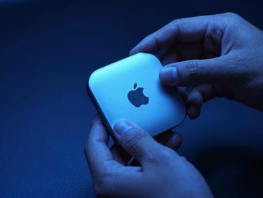 Sleek close-up of hands unboxing a premium minimalist tech accessory under moody blue studio lights, sharp focus
