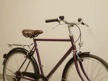 A classic Motobécane bicycle with drop handlebars, leather saddle, and shiny chrome fenders, clean workshop background, warm soft lighting, 35mm