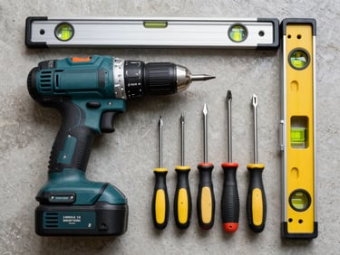 Flat-lay overhead shot of hand tools and power tools — a cordless drill, set of screwdrivers, and a spirit level arranged on a neutral concrete surface, bright fluorescent lighting, no styling